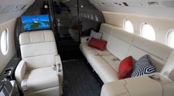 The overall design of this recently refurbished Falcon 900EX EASy is clean and masculine with a lot of leather and dark, heavily grained veneer, mixed with textures to help soften the overall space. It was completed by Duncan Aviation.