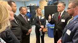 Indiana Federal Security Director Aaron Batt (second from right) explains security procedures to training participants and other guests at Indianapolis International Airport.